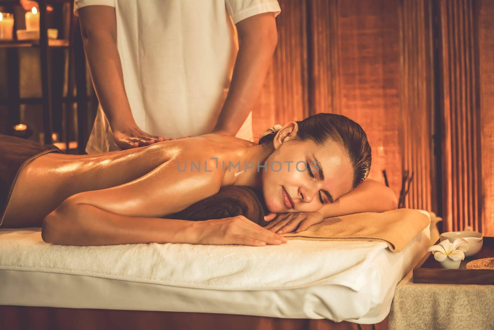 Caucasian woman customer enjoying relaxing anti-stress massage. Quiescent by biancoblue