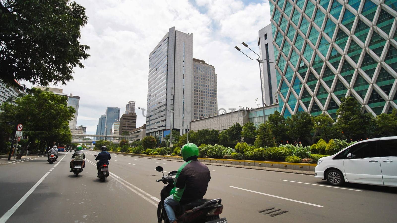 Jakarta's roads and streets with cars during the daytime. by DovidPro
