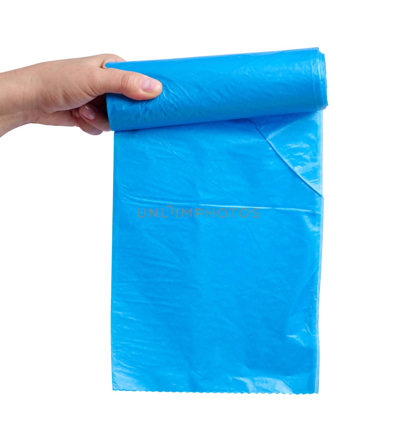 A woman's hand holds a roll of plastic bags for the trash can on a white isolated background