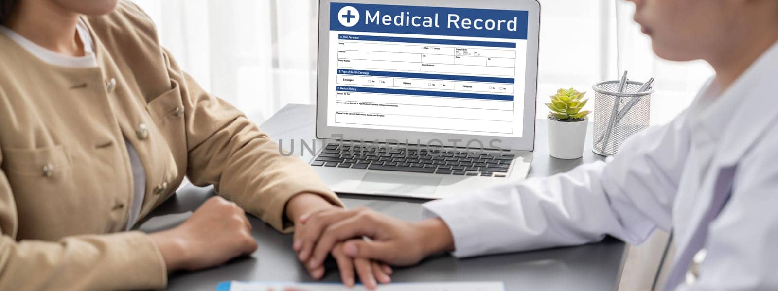 Doctor show medical diagnosis report on laptop to young patient. Neoteric by biancoblue