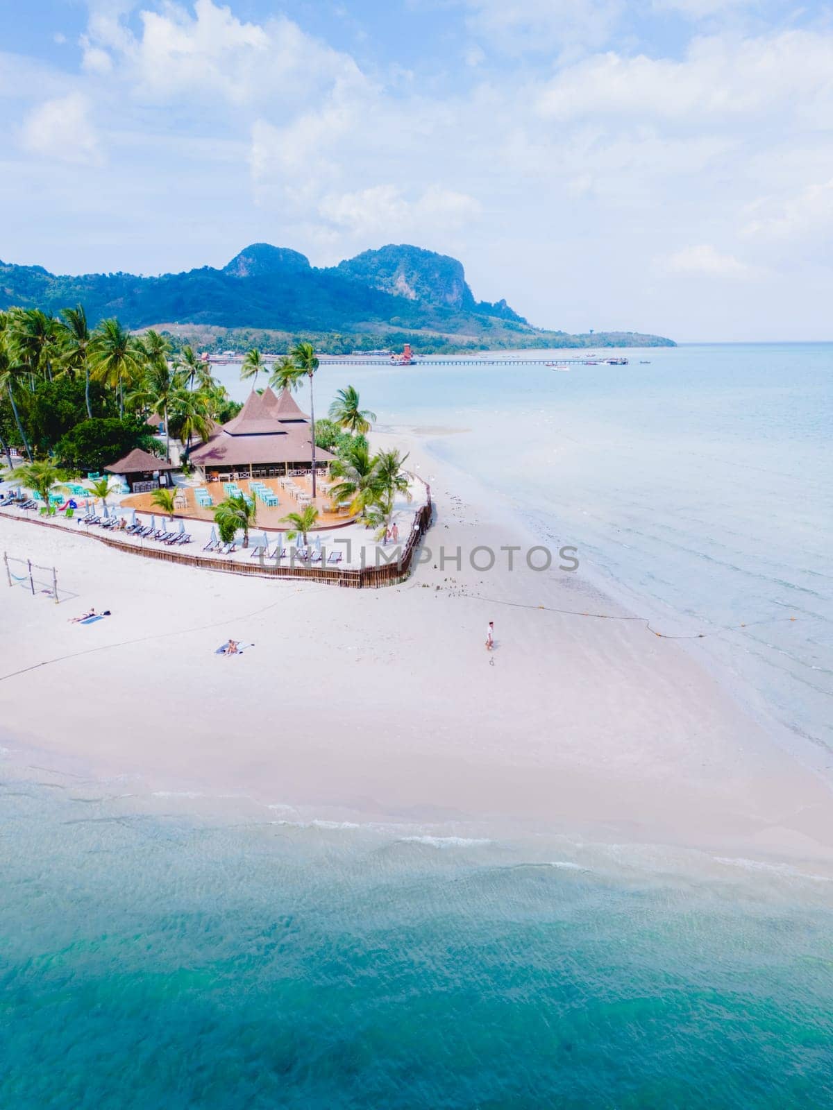 Drone aerial top view at Koh Muk a tropical island with palm trees and soft white sand, and a turqouse colored ocean in Koh Mook Trang Thailand