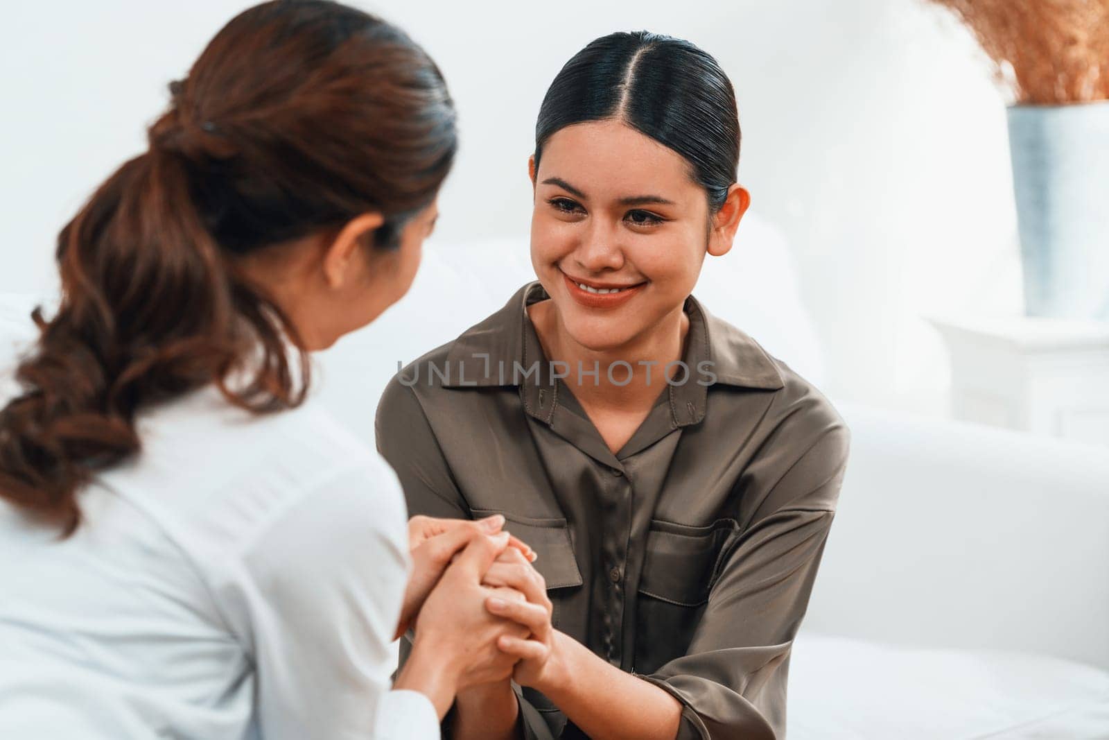 Sad PTSD woman patient in uttermost therapy for mental health with psychologist, depression or grief after life failure. Frustrated trauma young woman talking to a psychologist about emotion in clinic
