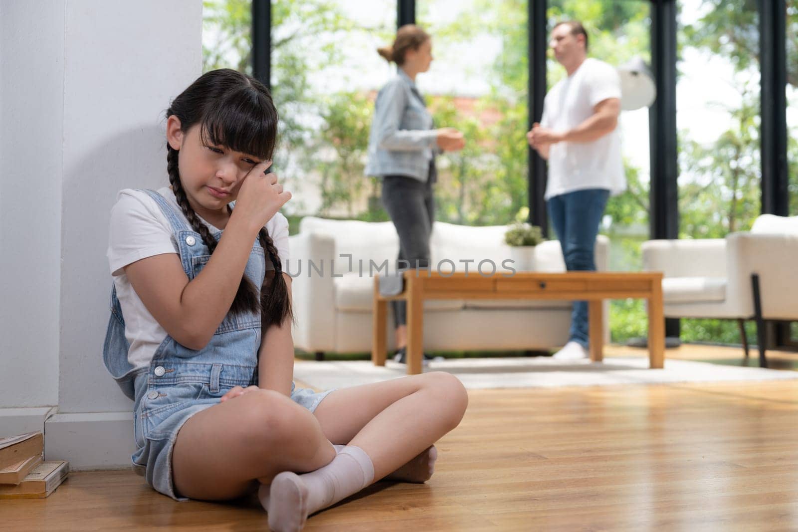 Stressed and unhappy young girl hide from domestic violence at home. Synchronos by biancoblue