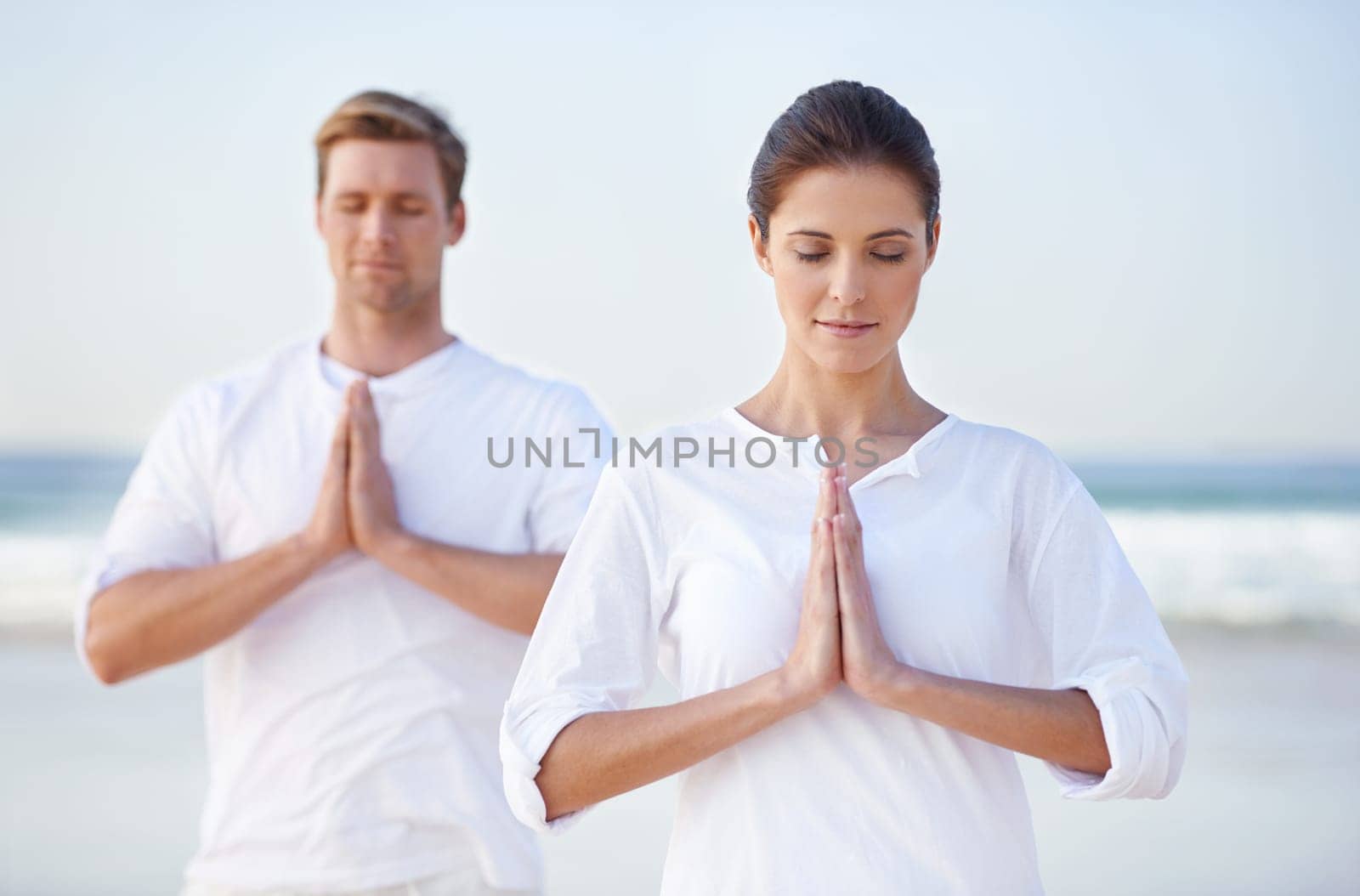Couple, yoga and meditation on beach, prayer for zen and wellness, travel and mindfulness with holistic healing. People outdoor, exercise and peace, workout together for bonding with sea and nature.