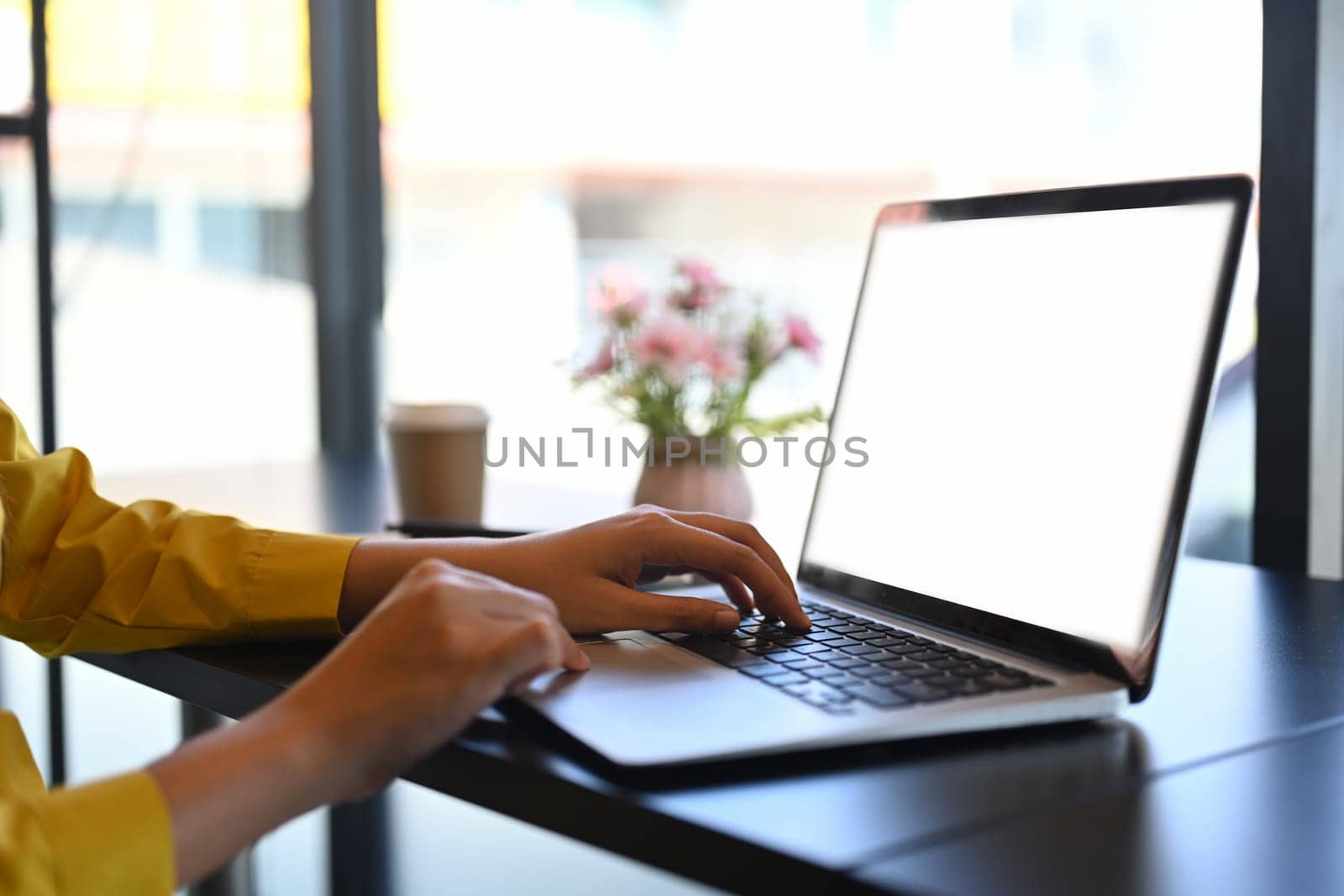 Woman hands typing on laptop keyboard, checking email or searching information.