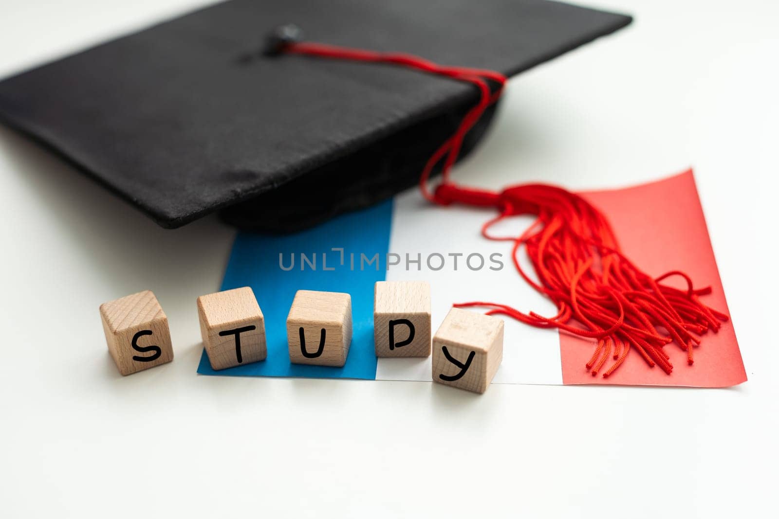 Graduation gap hat and wooden cubes, Education study testing learning teach concept. by Andelov13