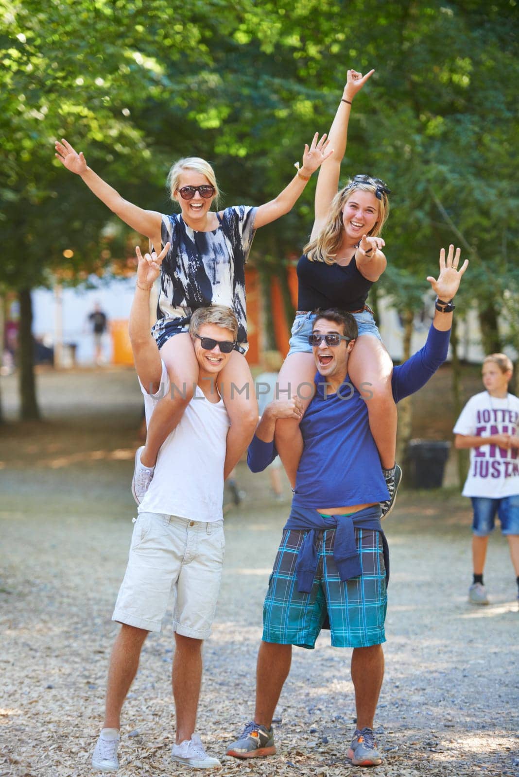 Friends, smile and excited celebration in forest together for cheerful, fun or bonding outdoors in park. Group of people, happy and crazy in summer for social event, festival or camping in nature by YuriArcurs