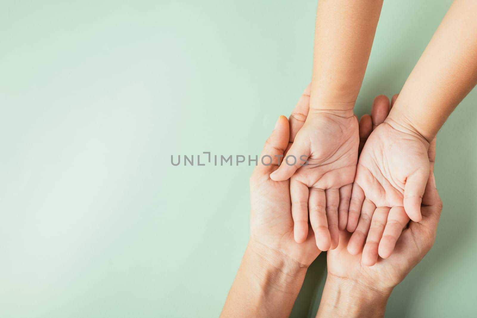 Top view of parents and kid holding empty hands isolated. Illustrating Family Day symbolizing togetherness and the legacy passed down. by Sorapop