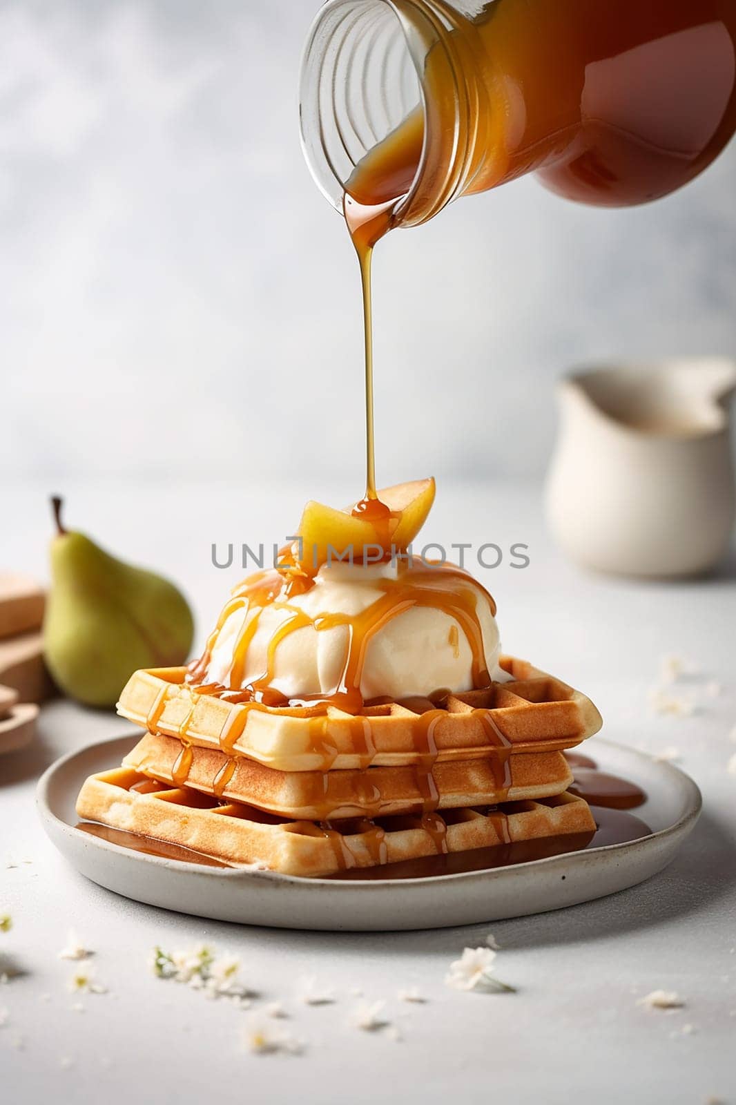 Vanilla ice cream on waffles drizzled with caramel sauce and nuts.