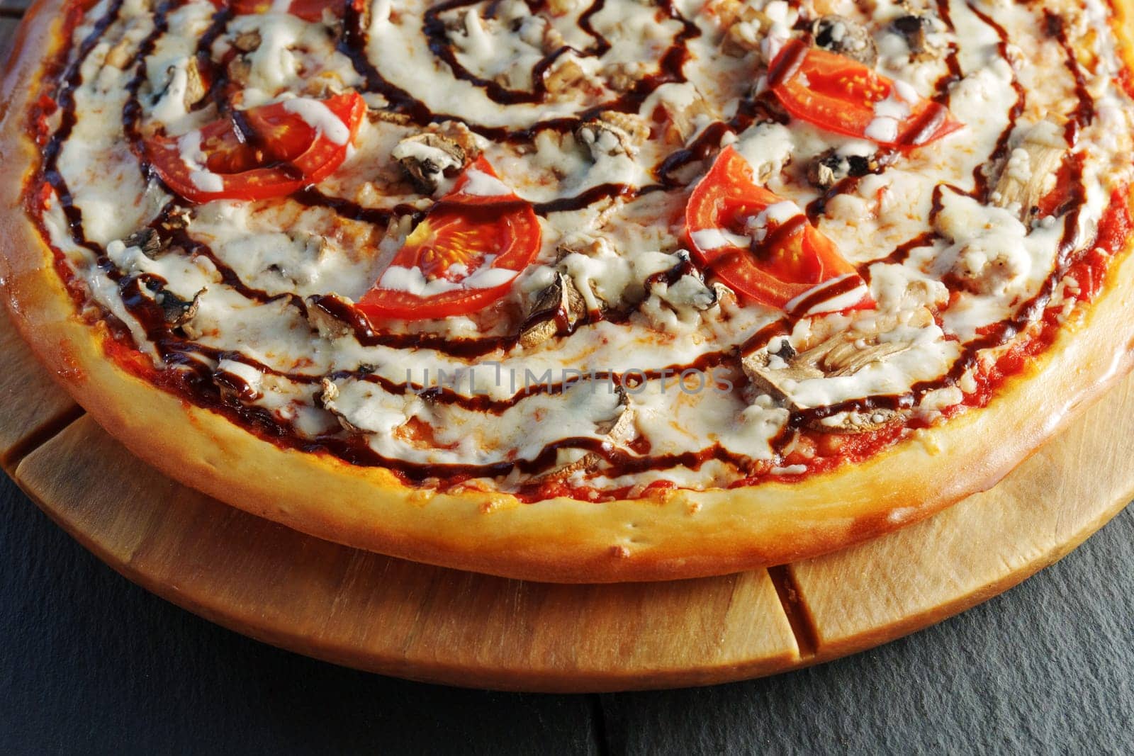 Freshly baked pizza with ripe tomatoes, earthy mushrooms, and melted cheese, ready to be enjoyed.