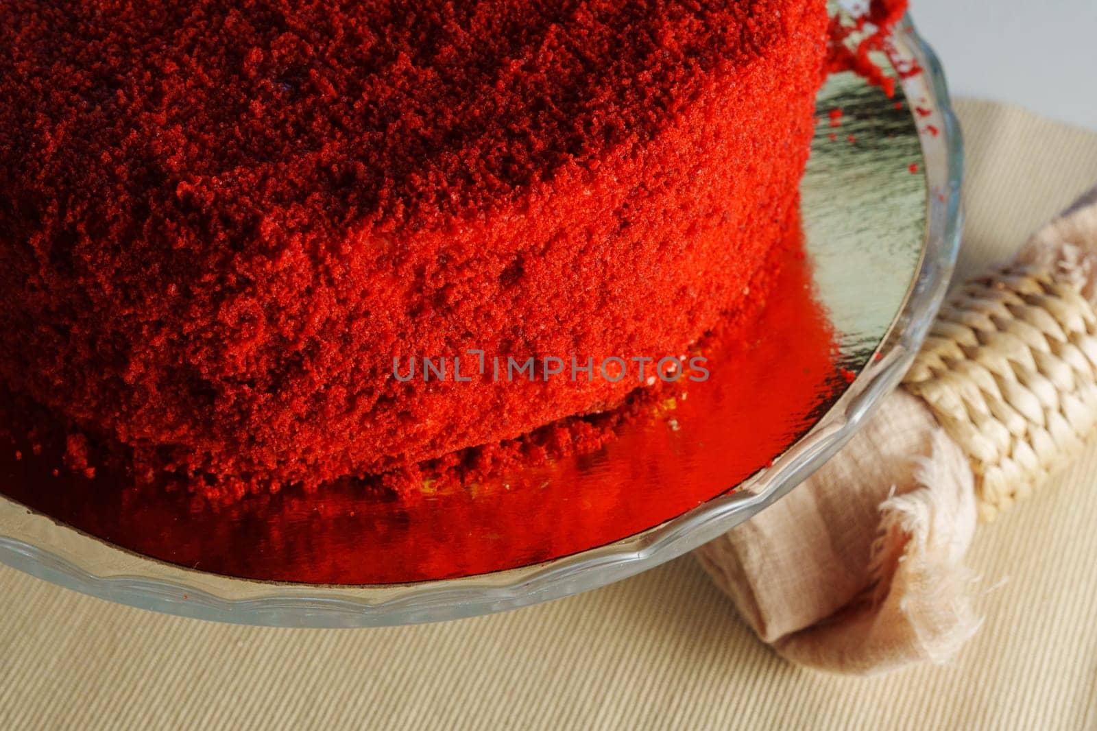 Red velvet cake takes center stage, served on a transparent glass dish by darksoul72