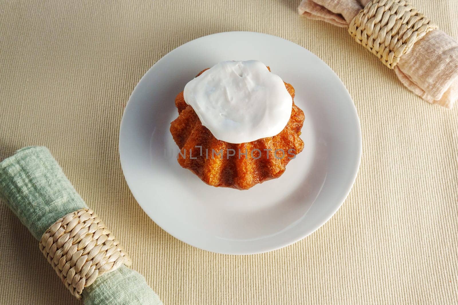 A tantalizing cupcake sits on a delicate plate, adorned with a fluffy mountain of whipped cream topping. by darksoul72