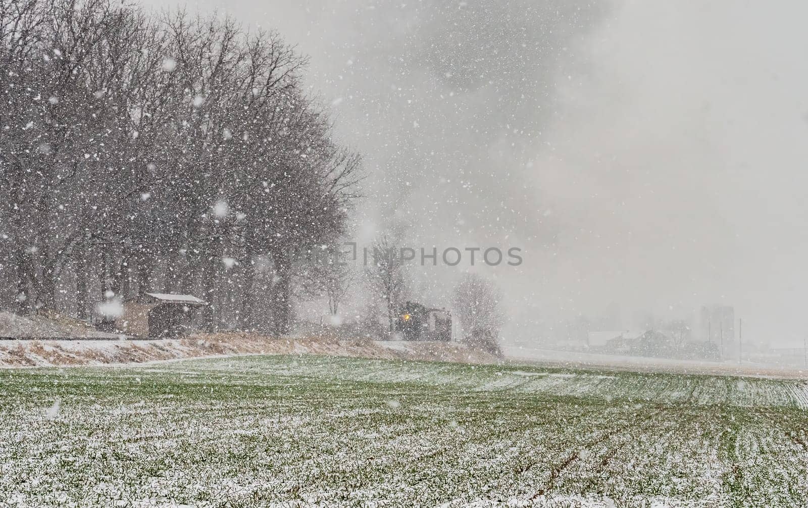 An Approaching Stem Passenger Train, in a Snow Storm, Blowing Black and White Smoke