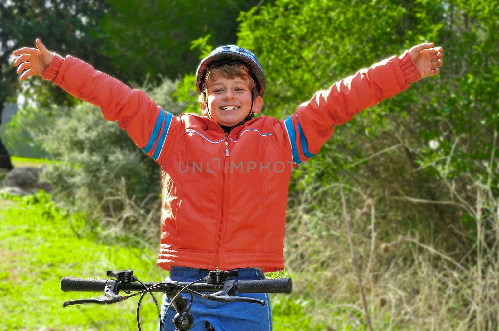 A boy rejoices after winning a bicycle race at a school competition