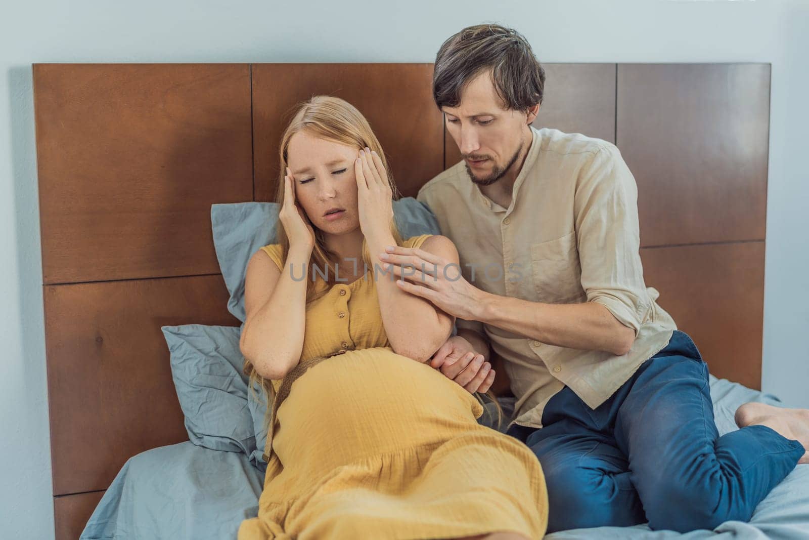 Expectant woman feels unwell, husband comforts and reassures her during a challenging pregnancy.