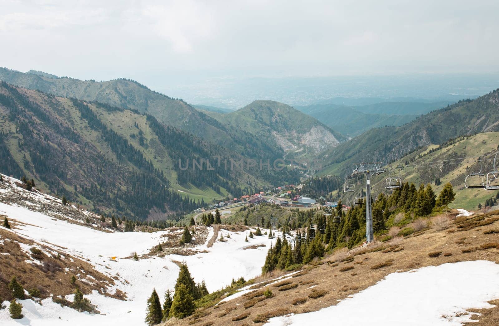 Picturesque Mountain Landscape with Lush Greenery and Snow-capped Peaks in the Distance by Pukhovskiy