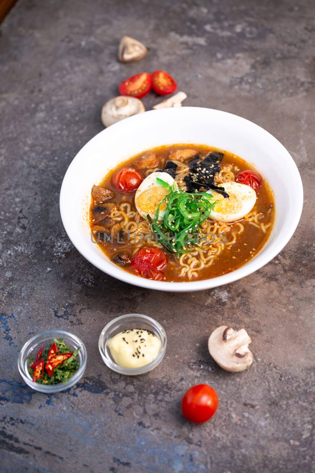 Savory Ramen Bowl with Colorful Fresh Ingredients on Dark Background by Pukhovskiy