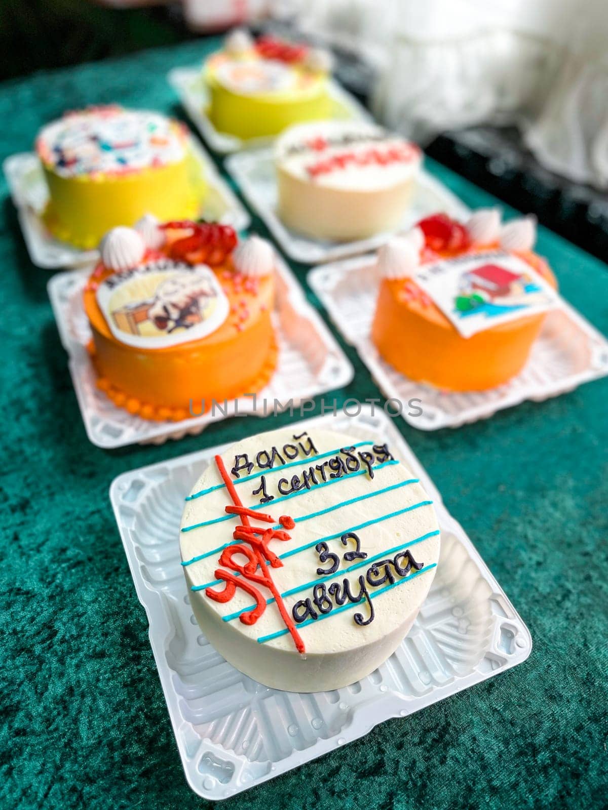 A round white cake with red and blue icing that says 1 September Knowledge Day. The cake is decorated with strawberries, blueberries, and whipped cream. Isolated on a white background.