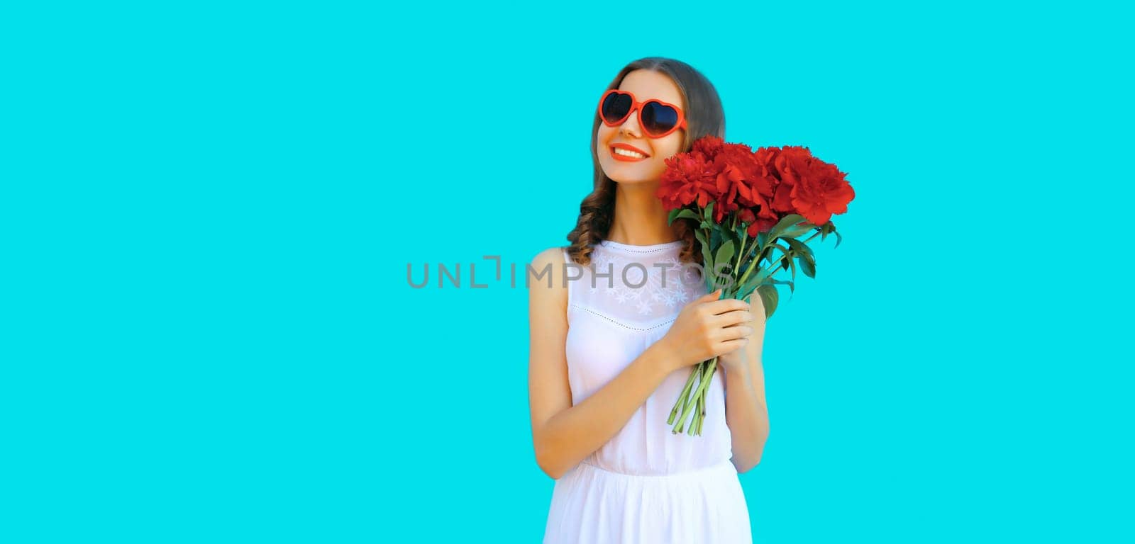 Portrait of beautiful smiling woman with bouquet of red rose flowers in heart shaped sunglasses by Rohappy