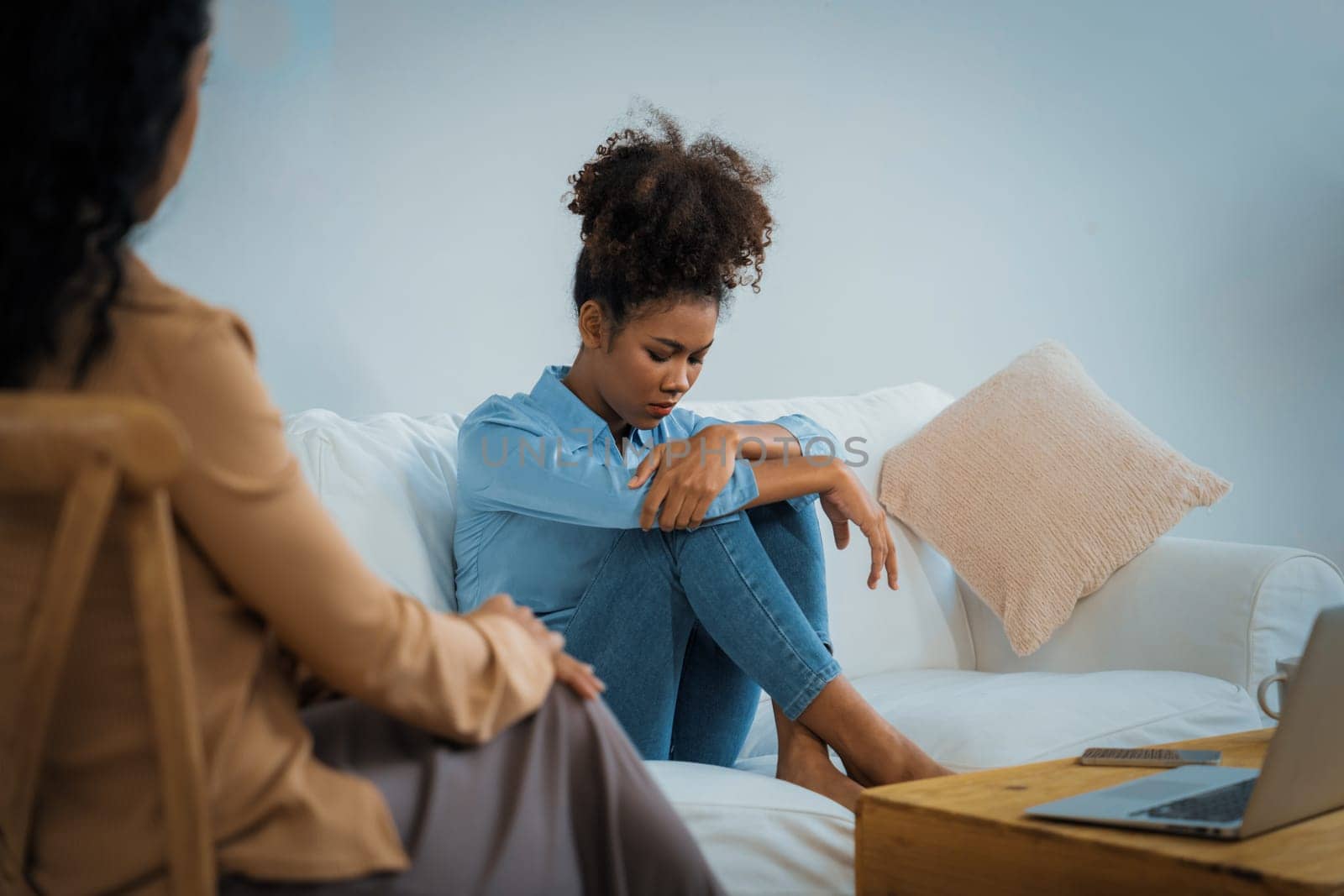 Sad PTSD woman patient in crucial therapy for mental health with psychologist, depression or grief after life failure. Frustrated trauma young woman talking to a psychologist about emotion in clinic