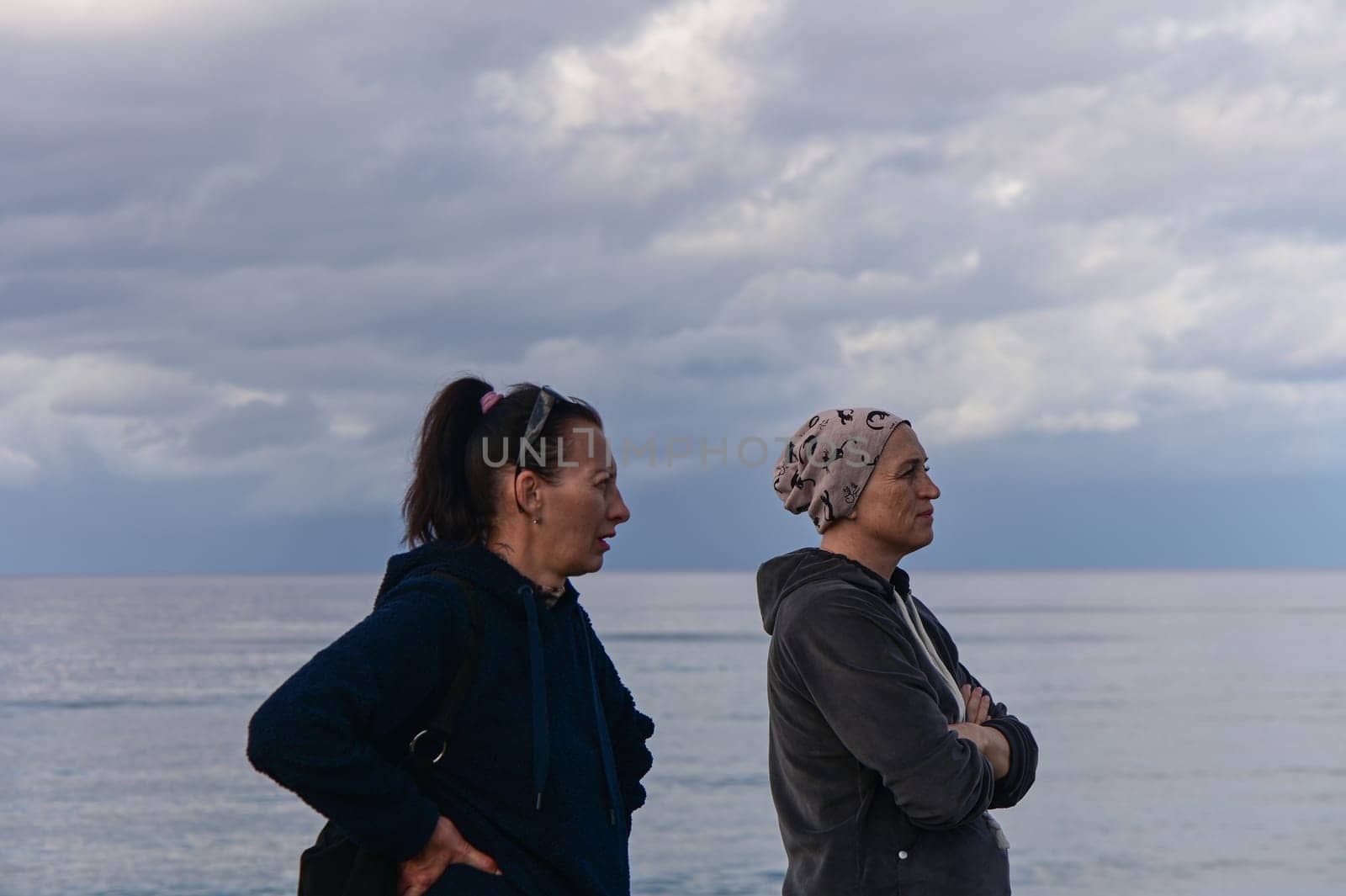 portrait of two women on the shores of the Mediterranean sea in winter