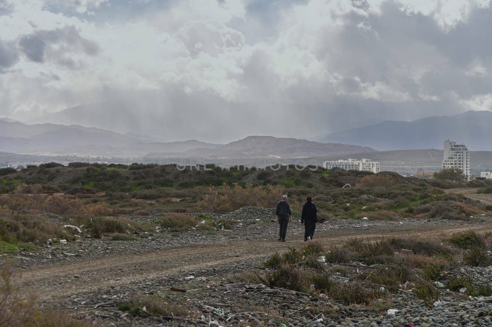 two women walking on the shores of the Mediterranean sea in winter