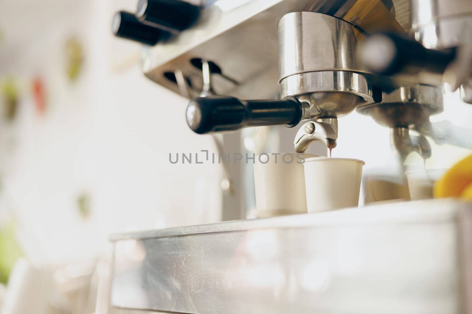 Coffee machine filling a two cups with espresso in professional coffee shop. High quality photo