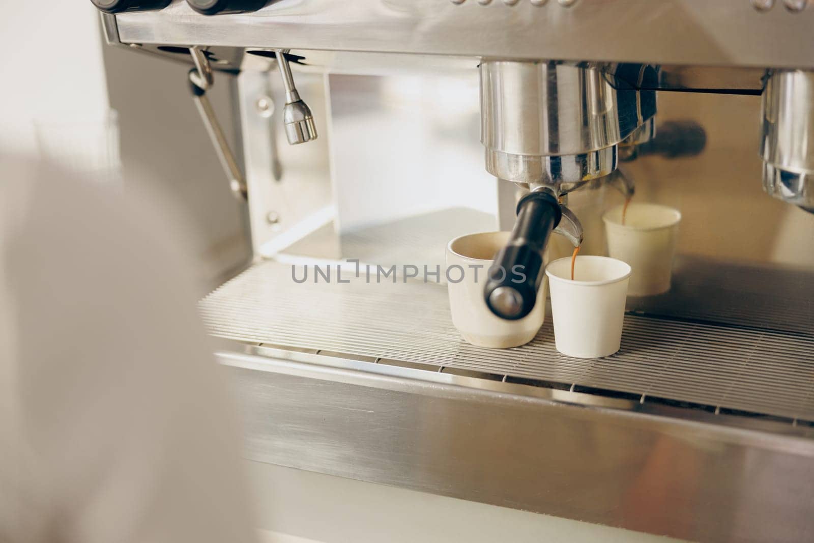 Coffee machine filling a two cups with espresso in professional coffee shop. High quality photo