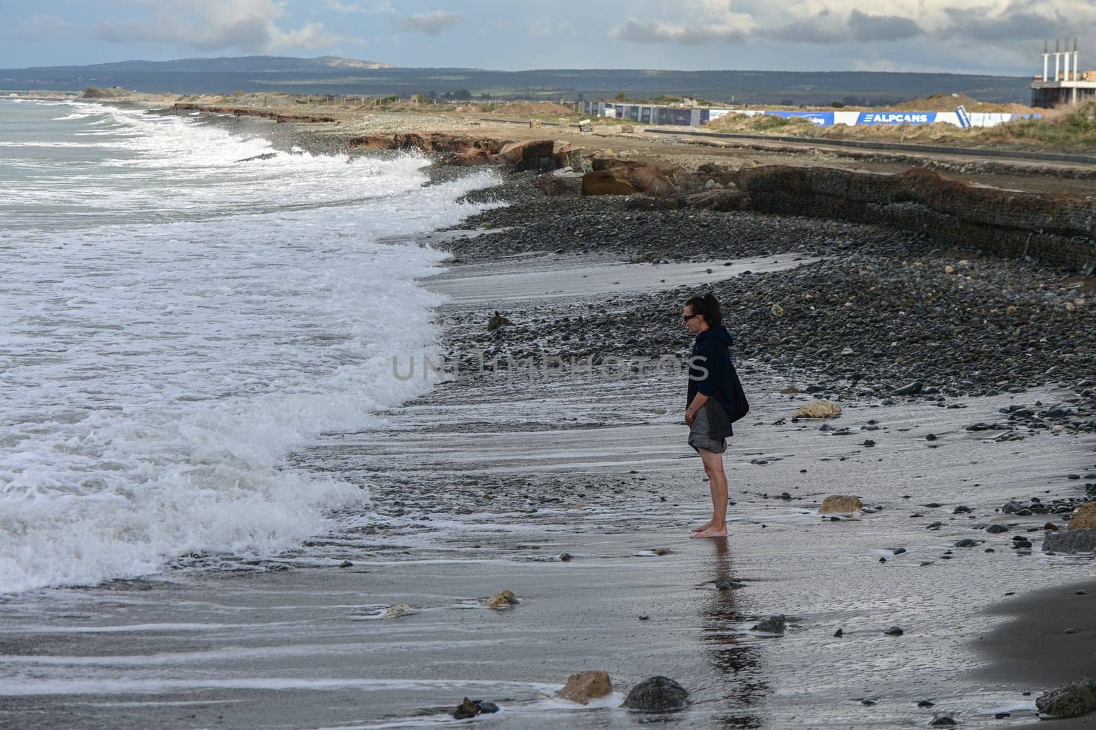 woman walks barefoot on the water in the Mediterranean Sea in Cyprus in winter 2023 4