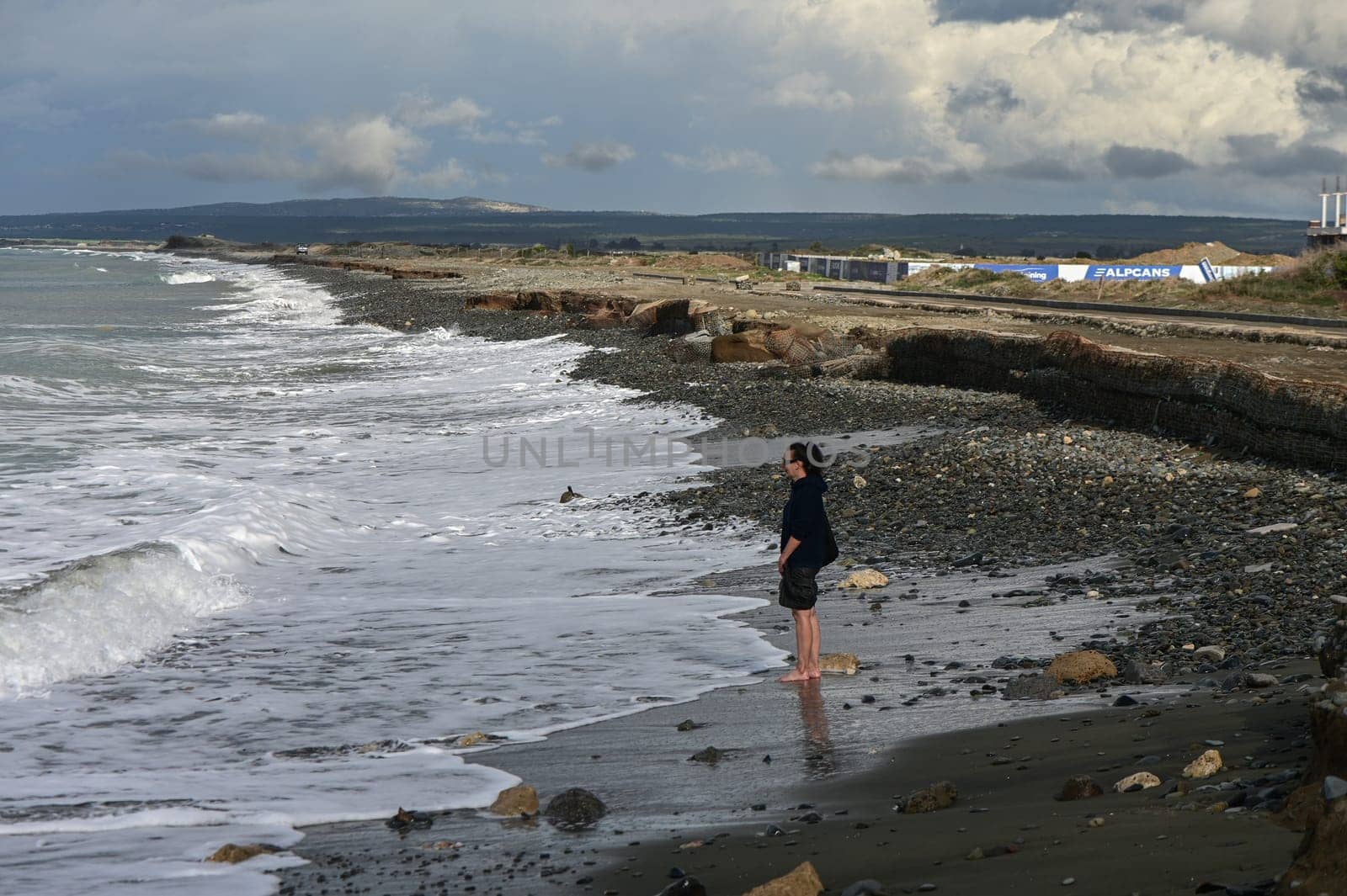 woman walks barefoot on the water in the Mediterranean Sea in Cyprus in winter 2023 3