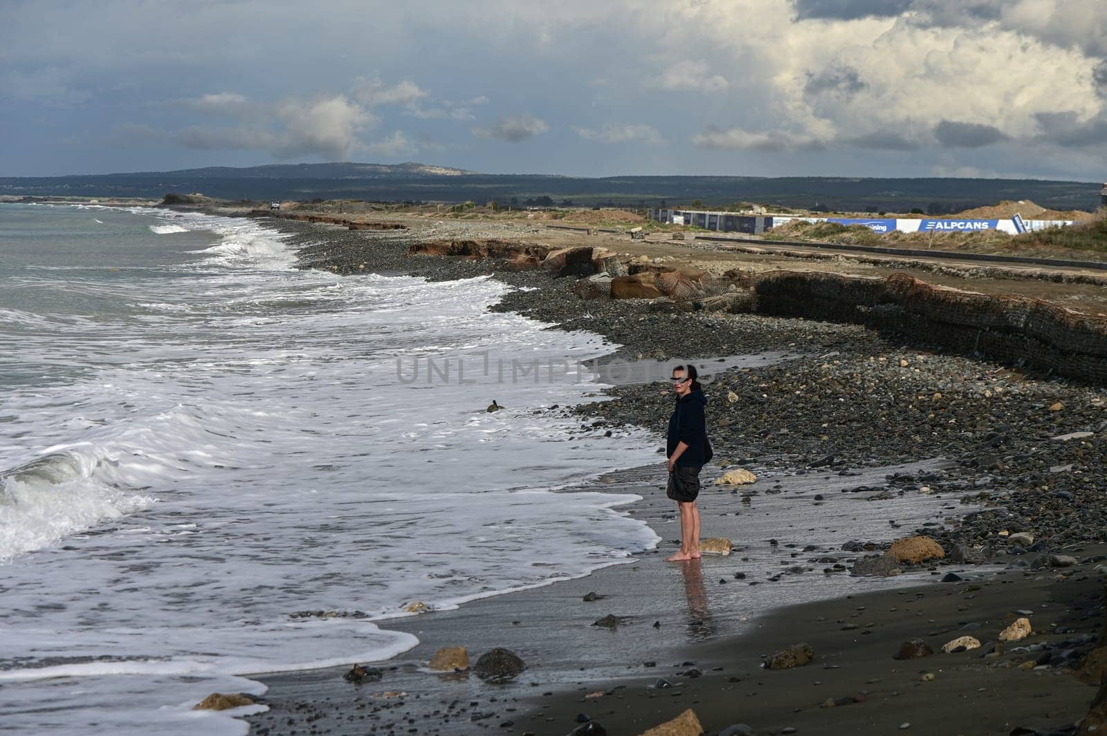 woman walks barefoot on the water in the Mediterranean Sea in Cyprus in winter 2023 3 by Mixa74