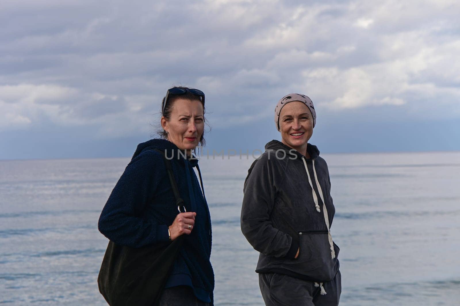 portrait of two women on the shores of the Mediterranean sea in winter 4