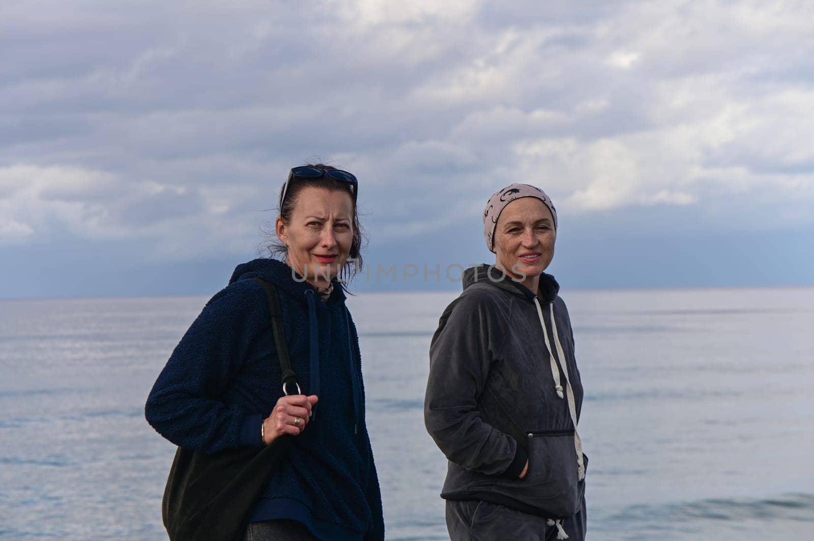 portrait of two women on the shores of the Mediterranean sea in winter 3