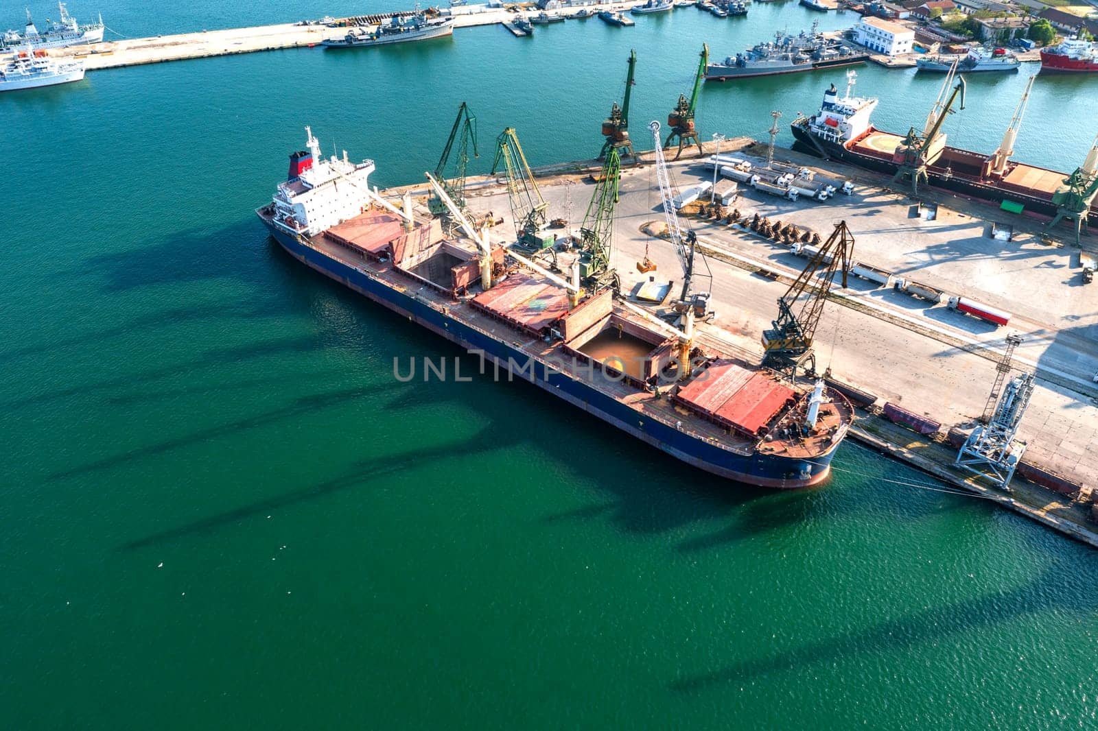 Aerial view from a drone of a large ship loading grain for export. Water transport  by EdVal