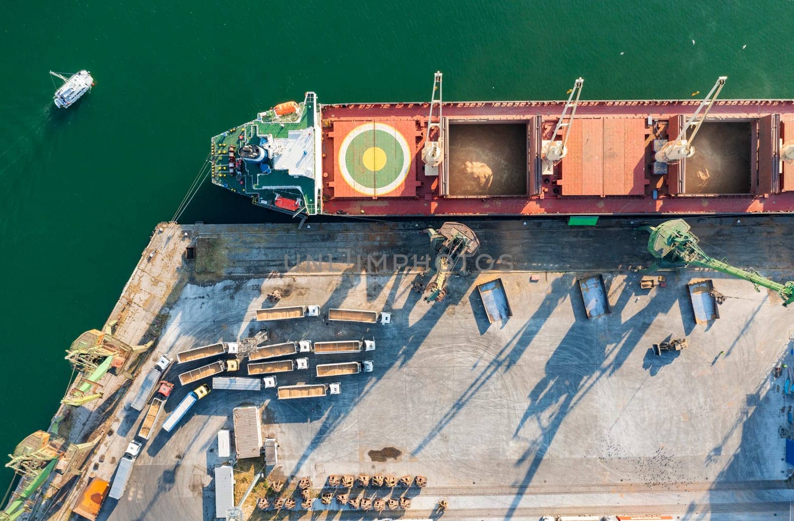 Top view from a drone of a large ship loading grain for export. Water transport 