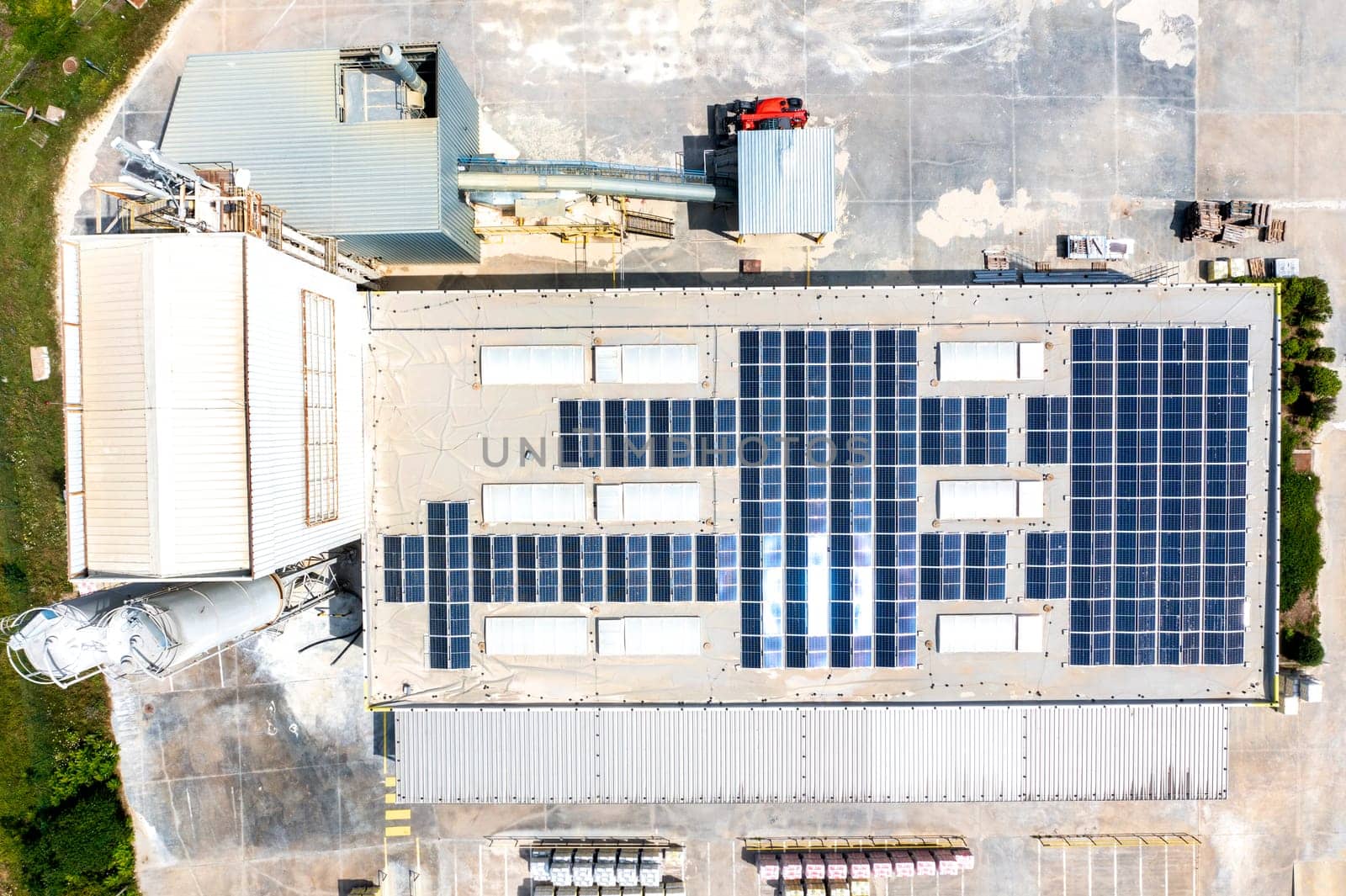 solar panels on the roof of a industrial building. Aerial view from drone  by EdVal