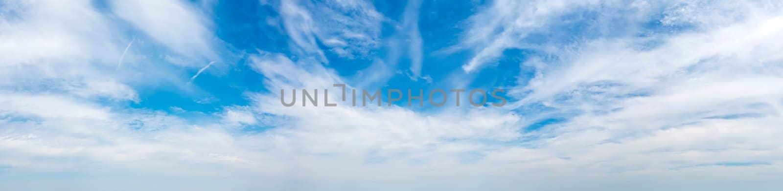 Panoramic view of blue sky with fluffy clouds 