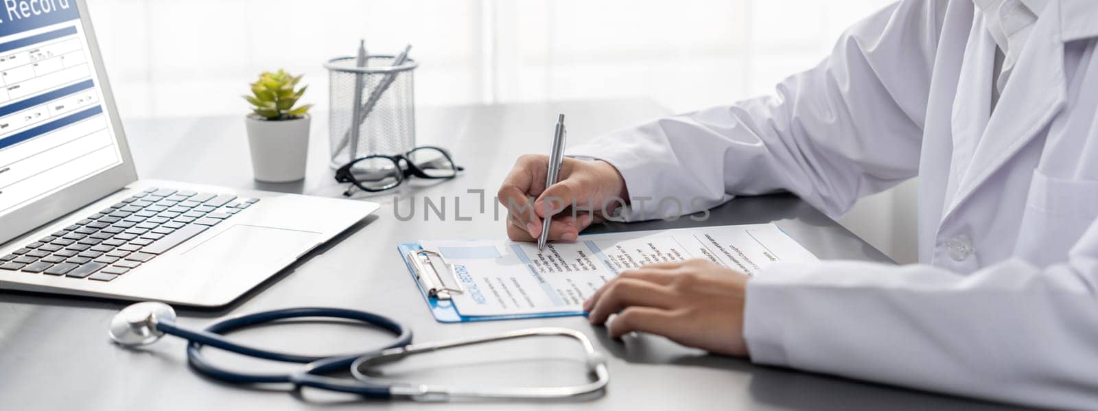 Doctor carefully review detailed medical report with laptop. Neoteric by biancoblue