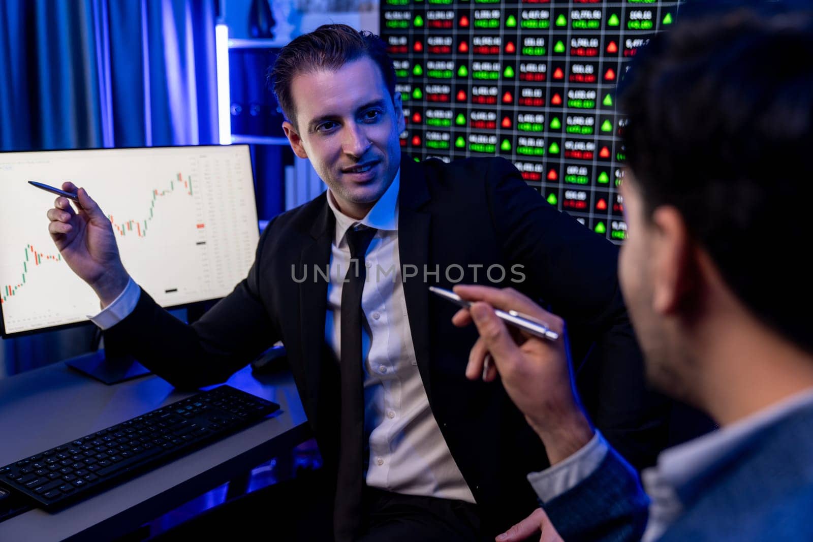 Two stock exchange traders discussing on dynamic investment graph. Sellable. by biancoblue