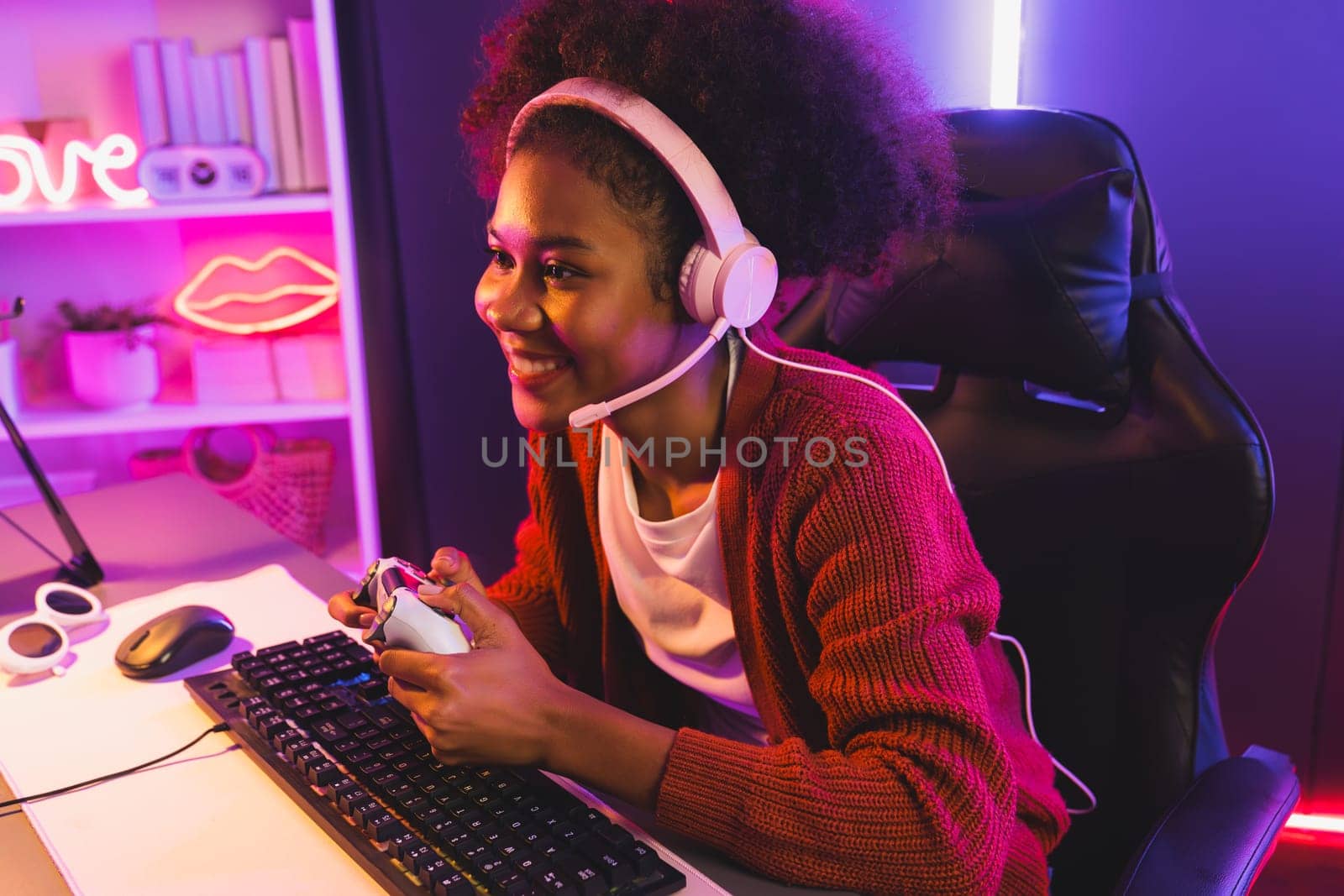 Host channel of gaming streamer, African girl wining with Esport skilled team player and viewers online game in neon color lighting room. Concept of cybersport indoor activities. Tastemaker.