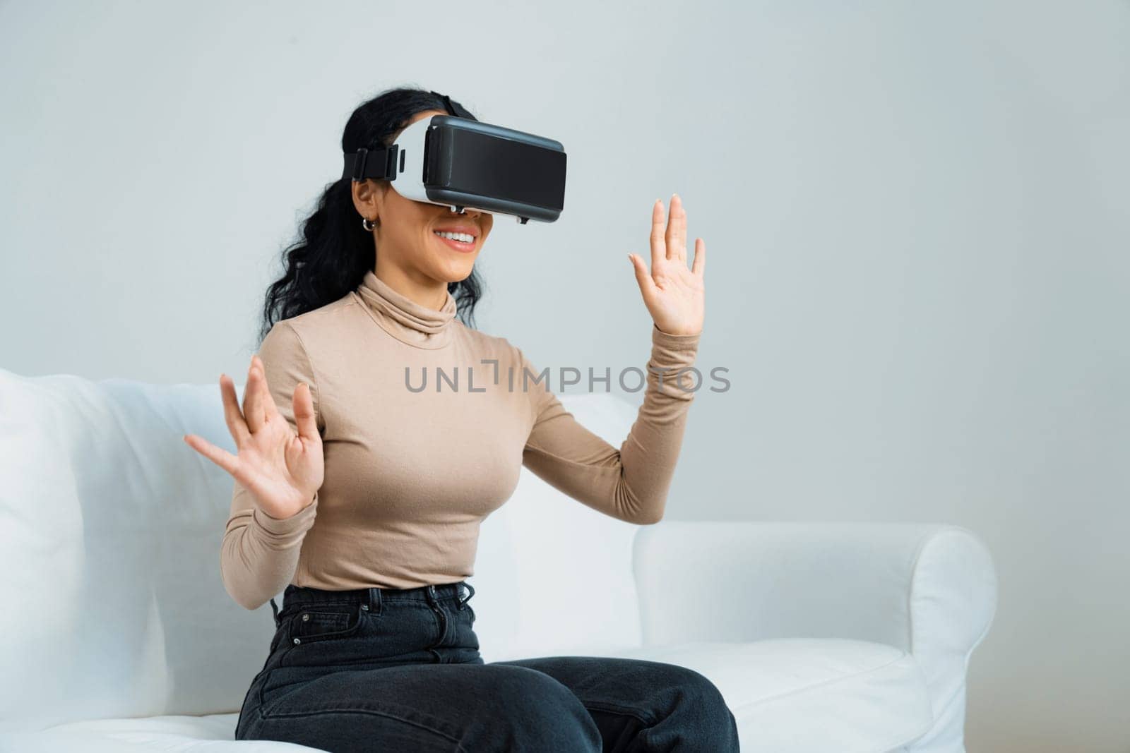 Young woman using virtual reality VR goggle at home for crucial online shopping experience. The virtual reality VR innovation optimized for female digital entertainment lifestyle.