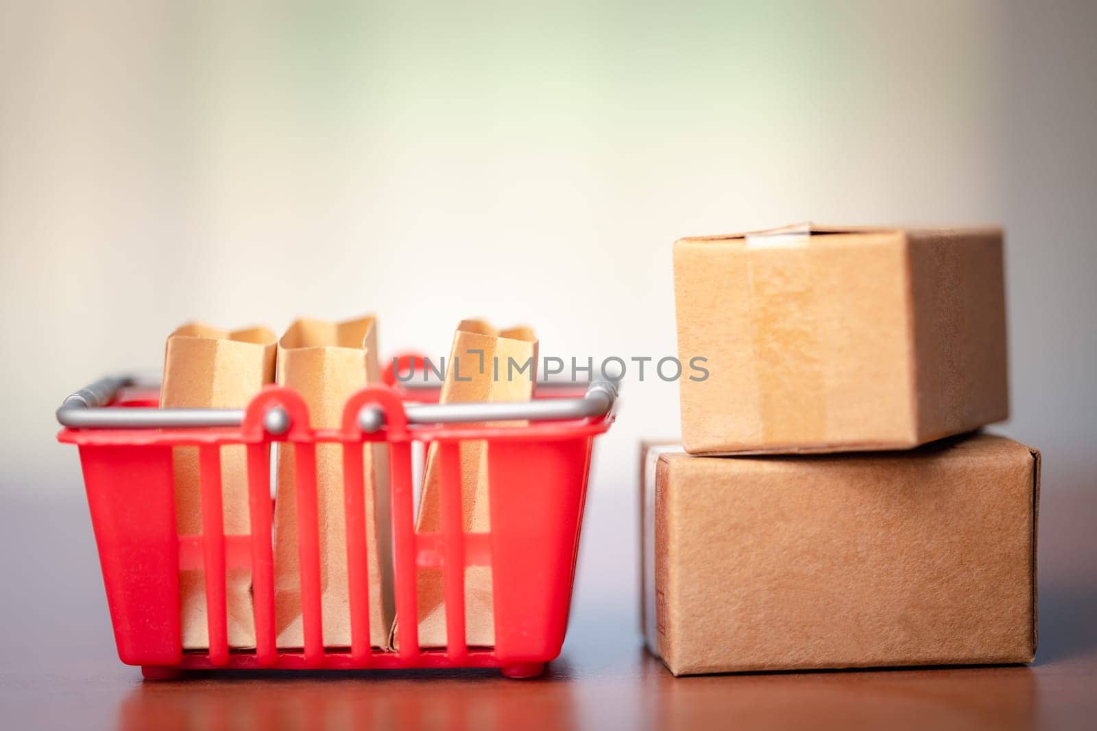 Shopping cart and boxes on wooden table by iamnoonmai