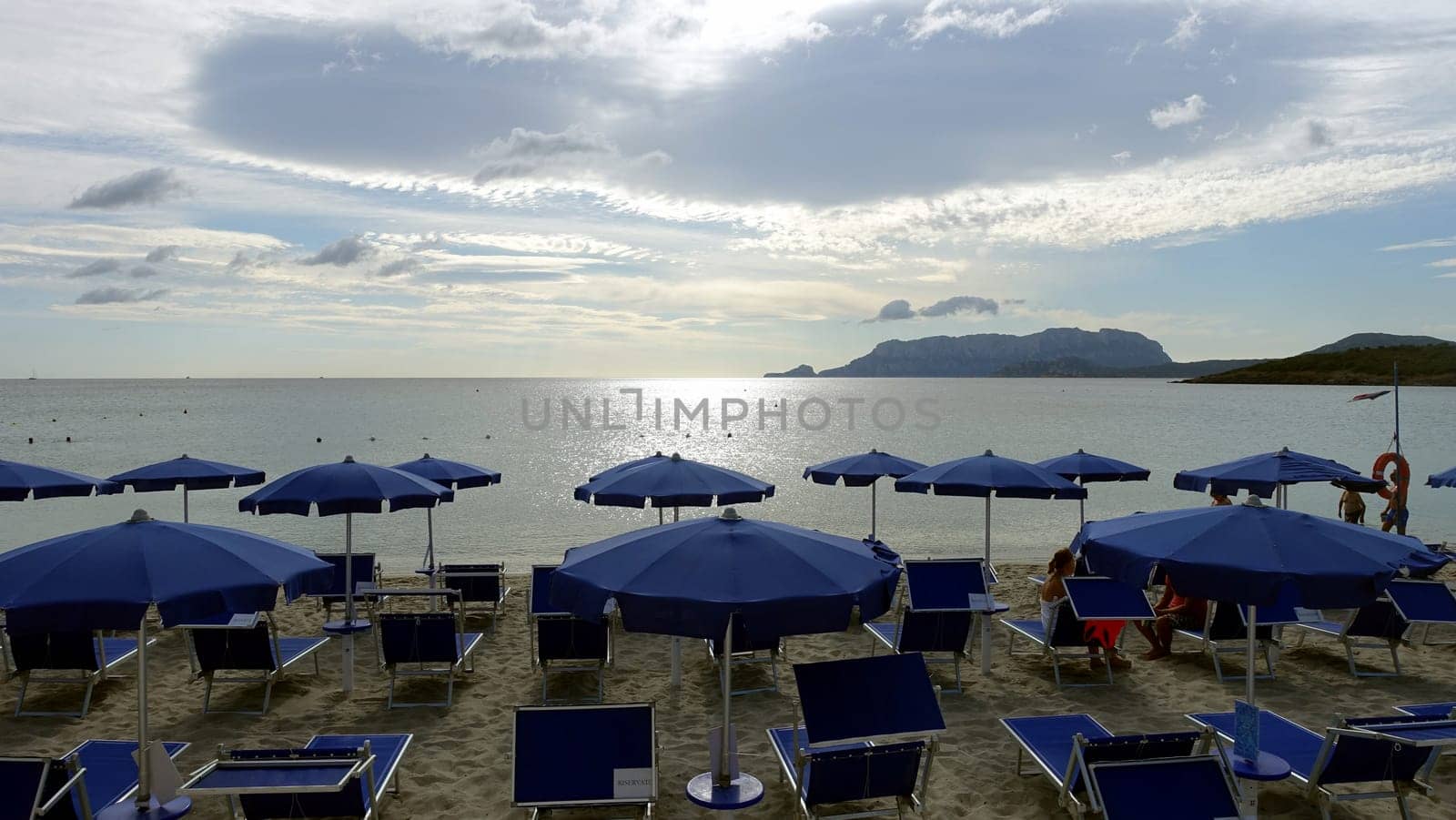Olbia, Sardinia, Italy. August 8 2021. One of the equipped beaches during a cloudy day. by Jamaladeen