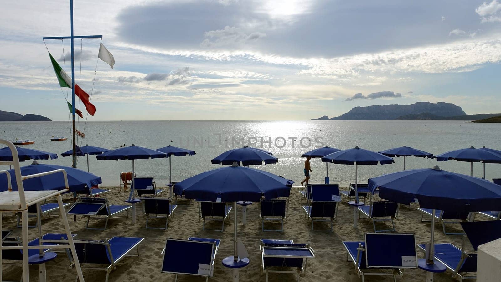 Olbia, Sardinia, Italy. August 8 2021. One of the equipped beaches during a sunny and cloudy day.