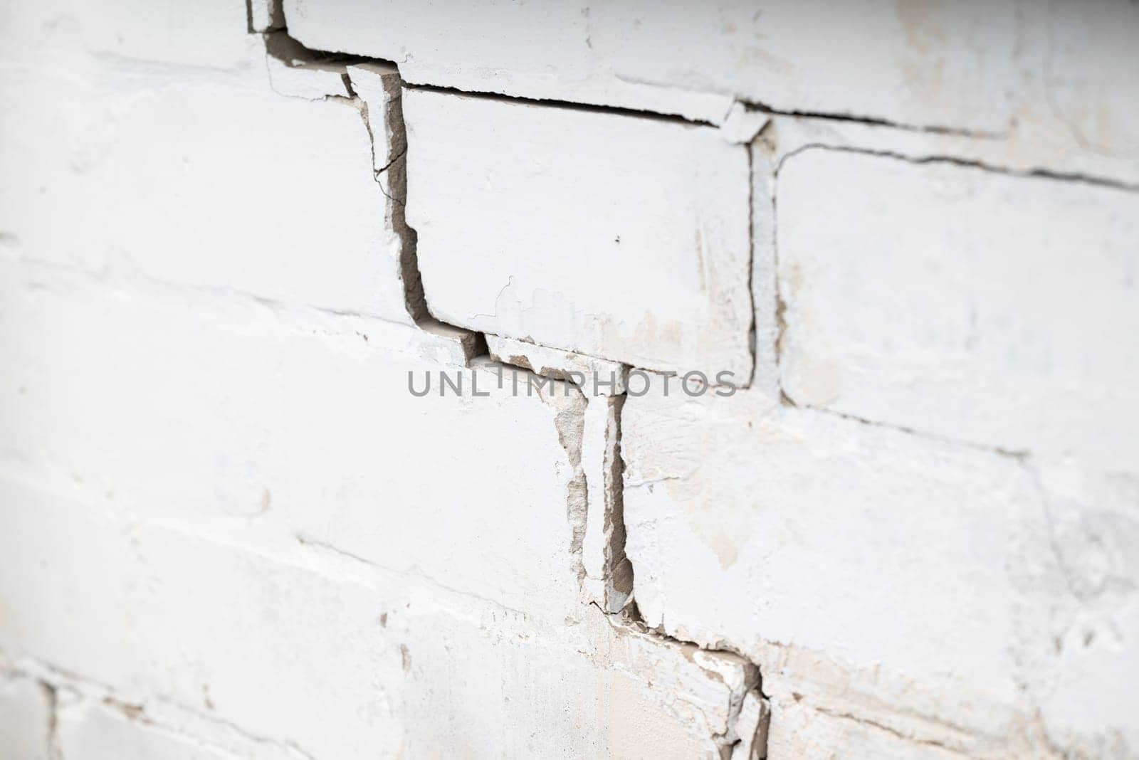 Crack on the white brick wall by VitaliiPetrushenko