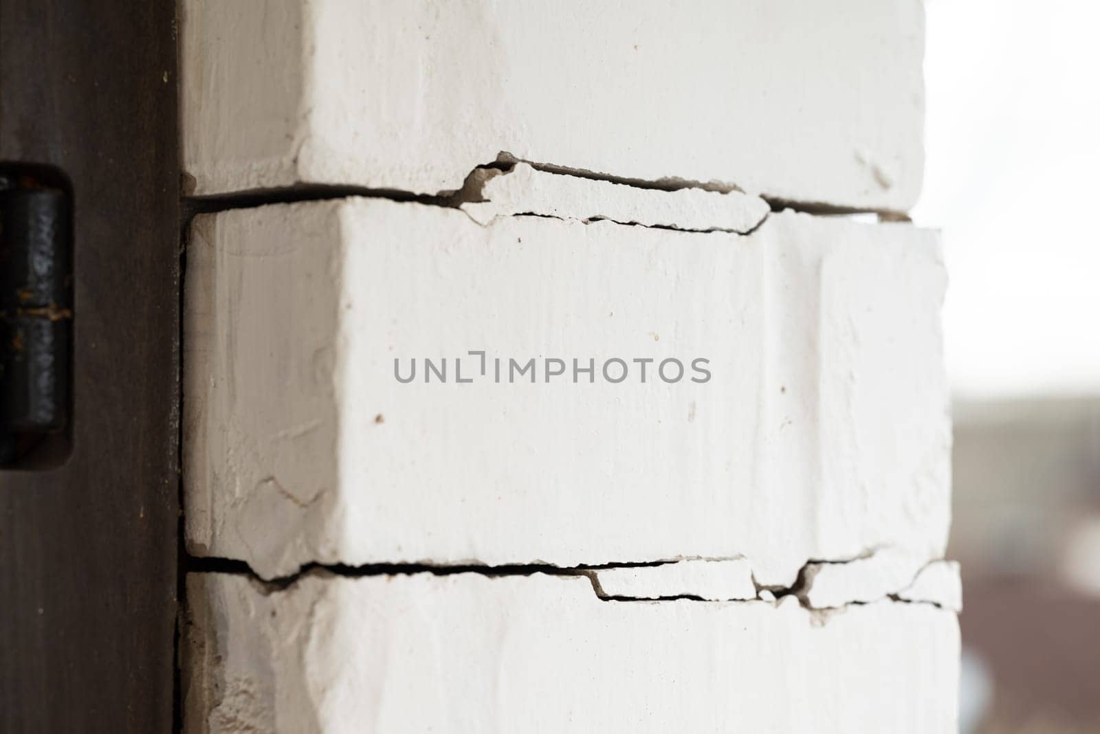 Brick wall of a house with cracks by VitaliiPetrushenko