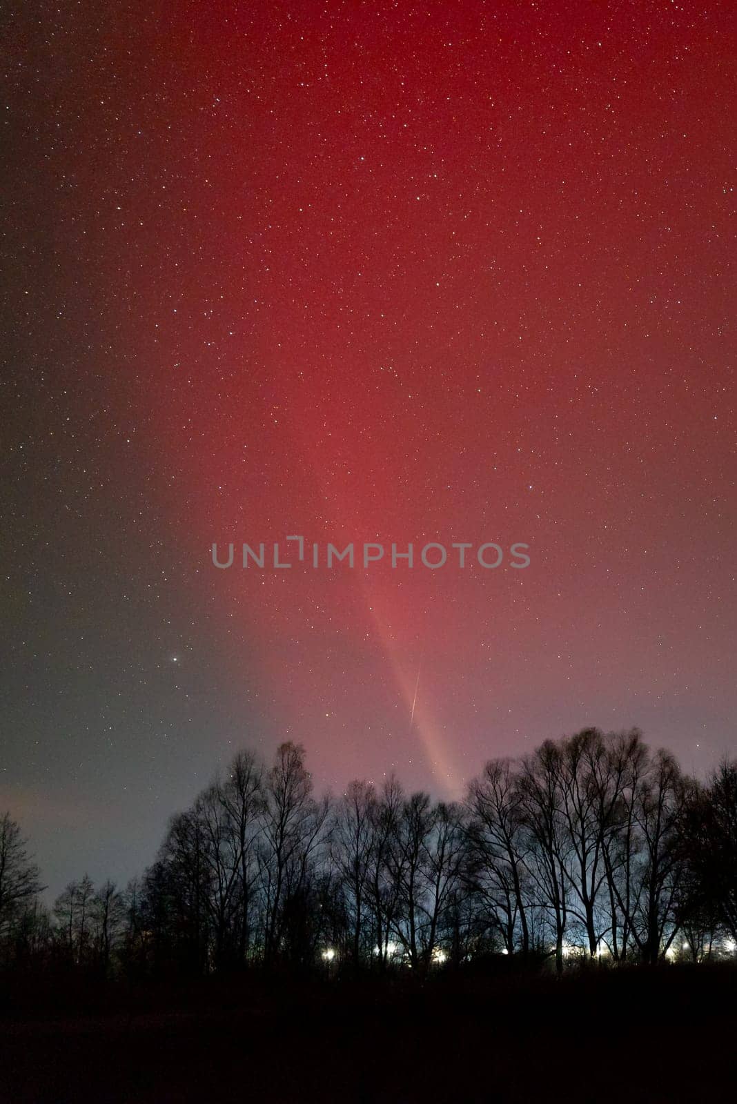 Bright red pillar of light in sky above some settlement by VitaliiPetrushenko