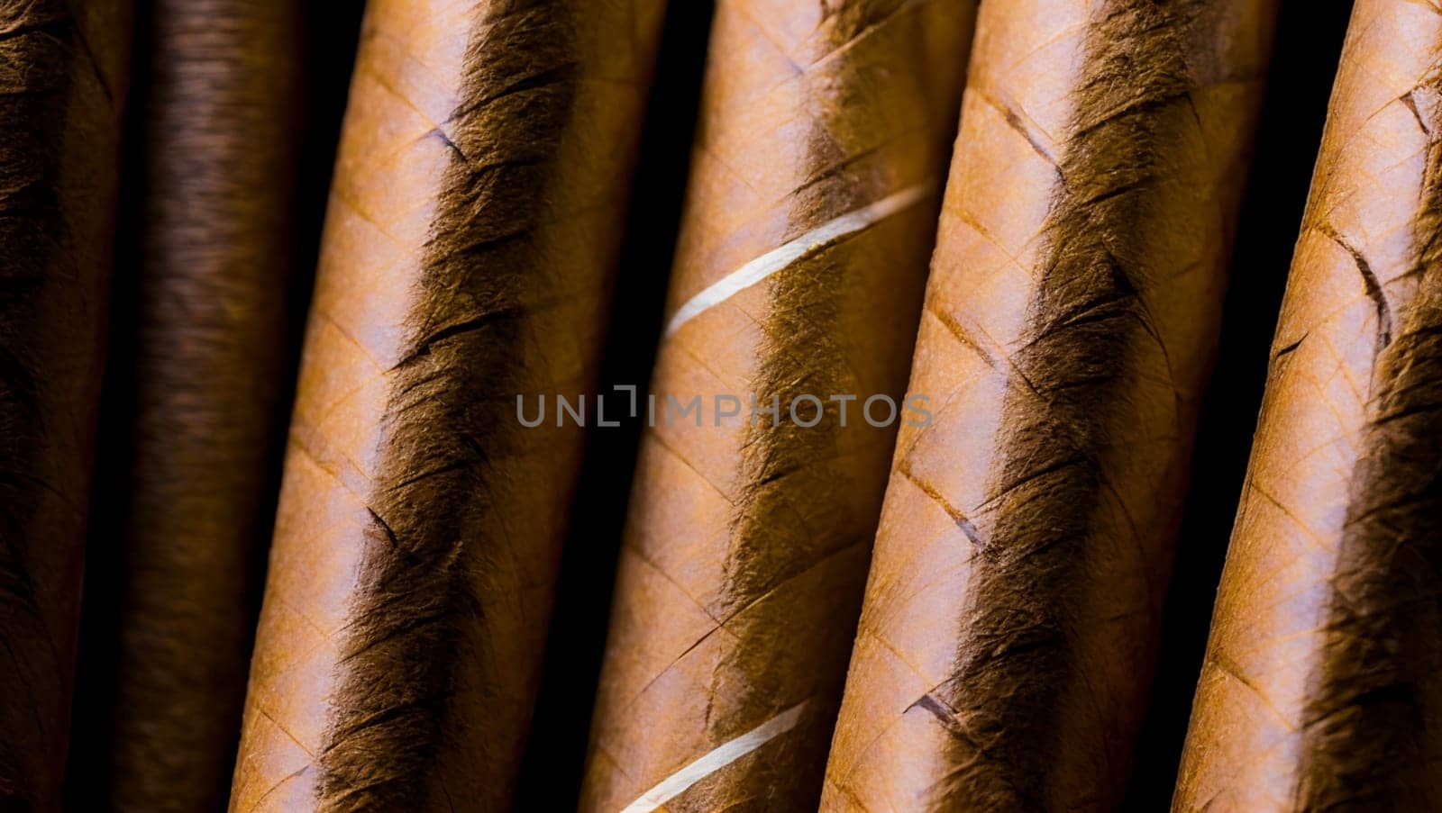 Detail of cigars with brown tobacco cover and white stripes. by XabiDonostia