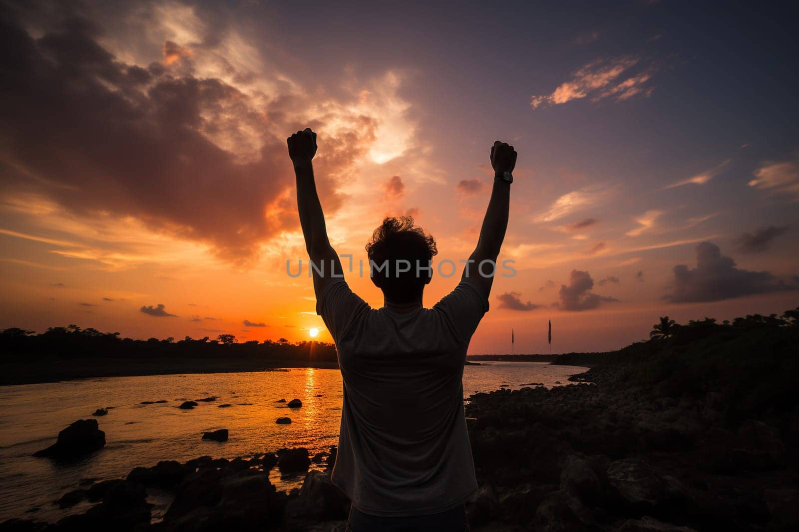 Silhouette of a happy man with his hands raised up against the backdrop of a sunset or dawn. Generated by artificial intelligence by Vovmar