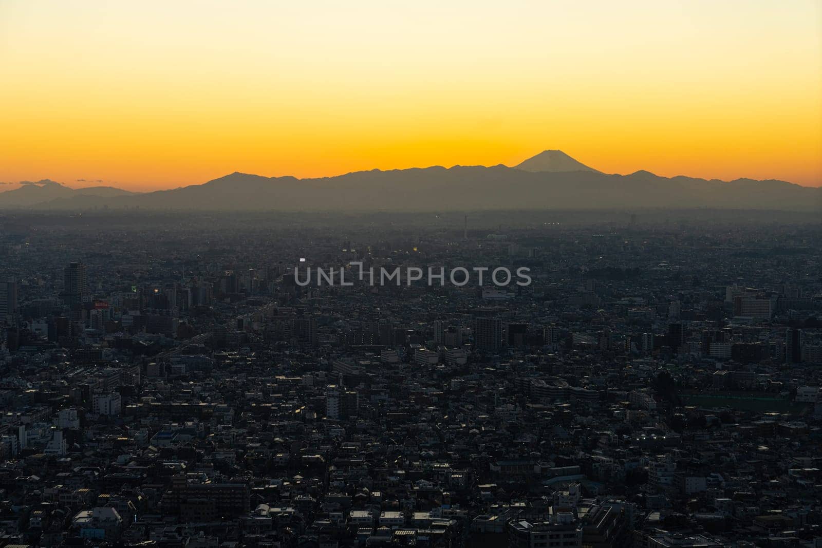 Tokyo, Japan. January 9, 2024. Mount Fuji seen at sunset from the city center